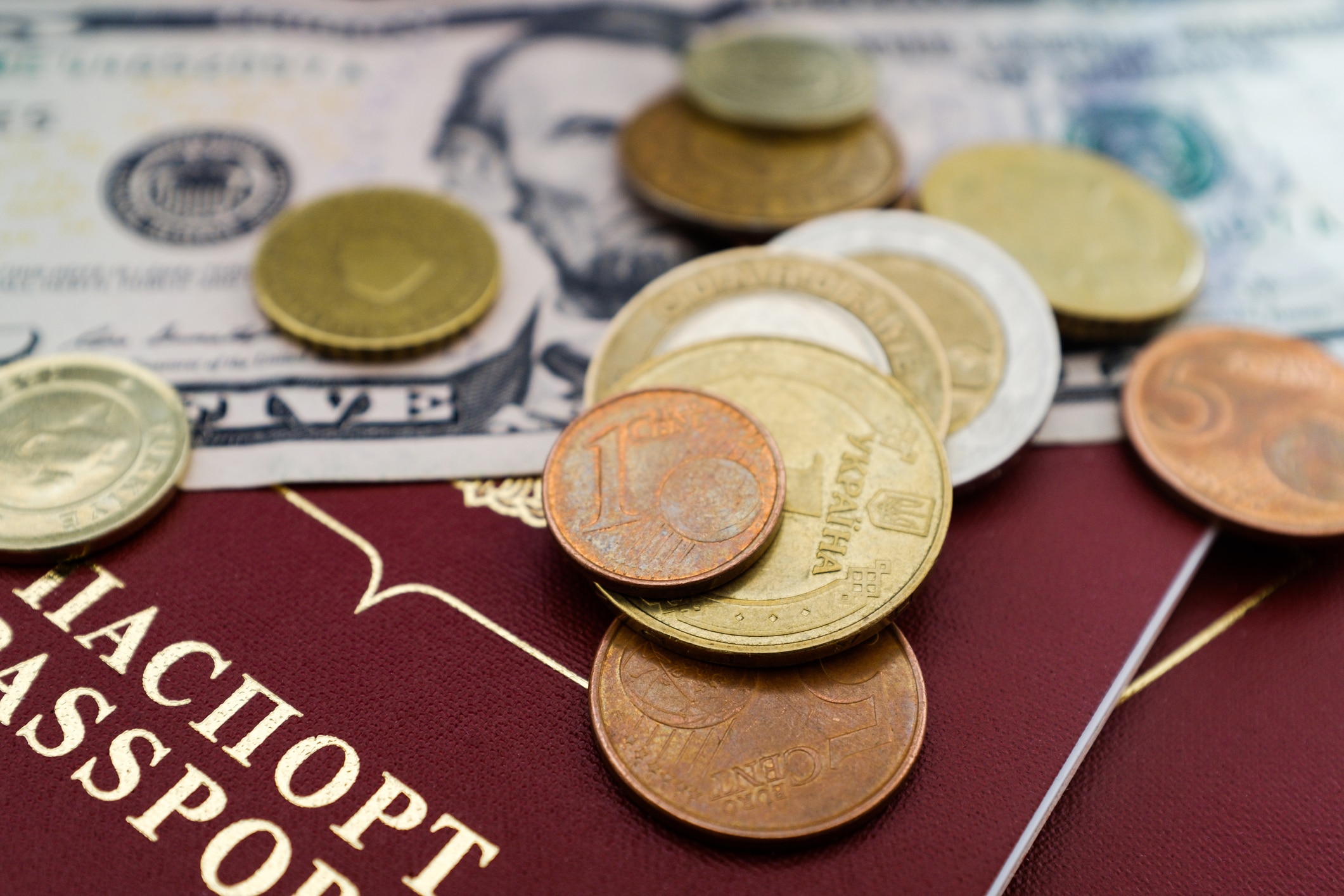 Coins placed on passports and banknotes representing currency and document authentication