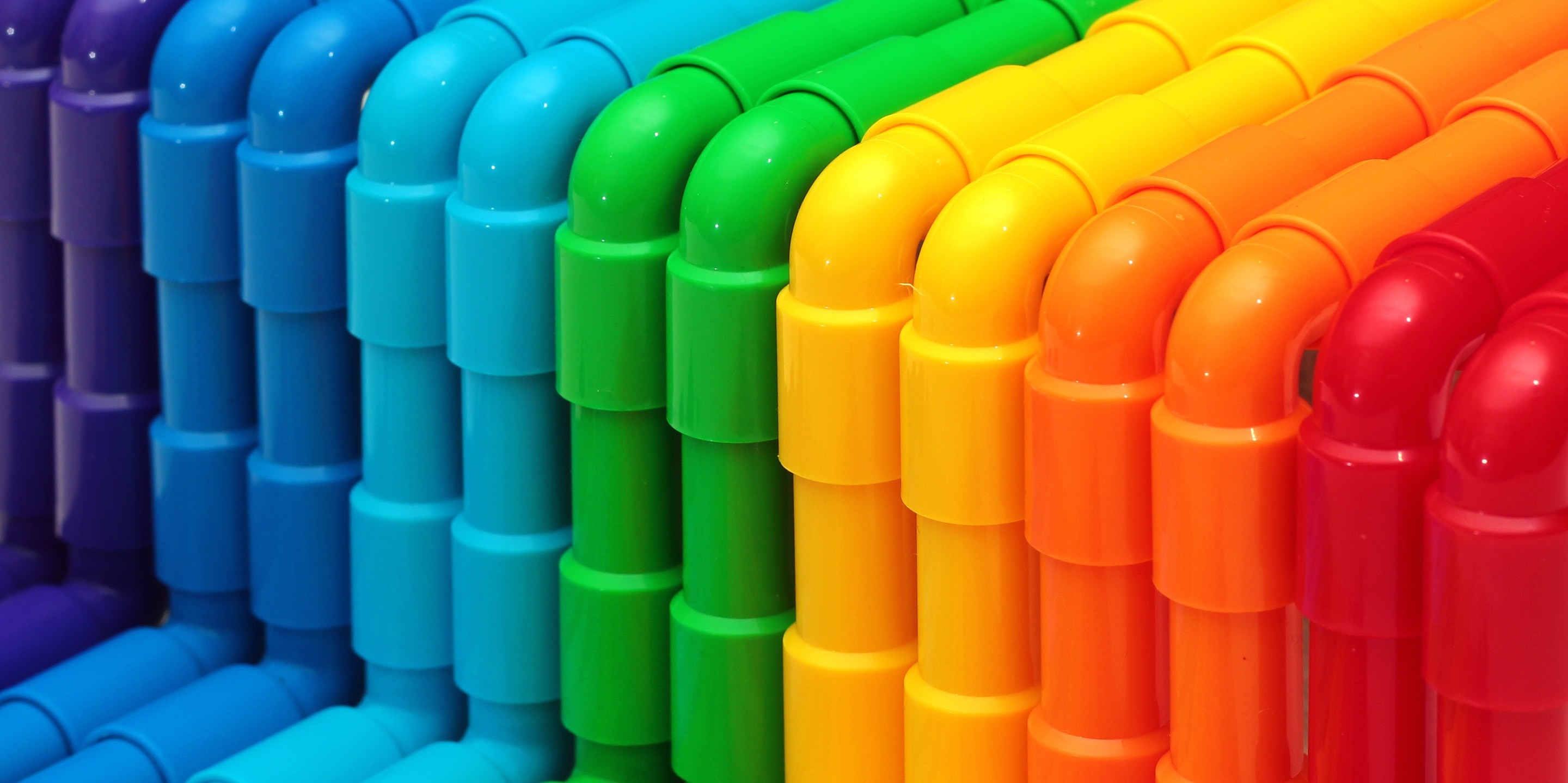 Rainbow colored plastic pipes as background