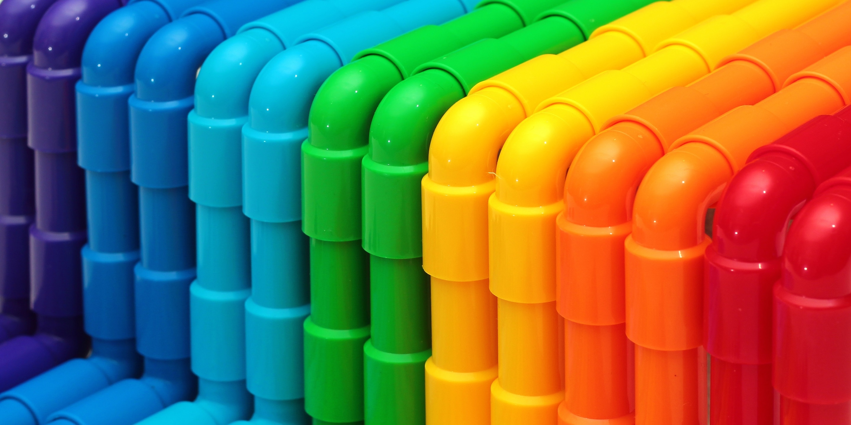 Rainbow colored plastic pipes as background