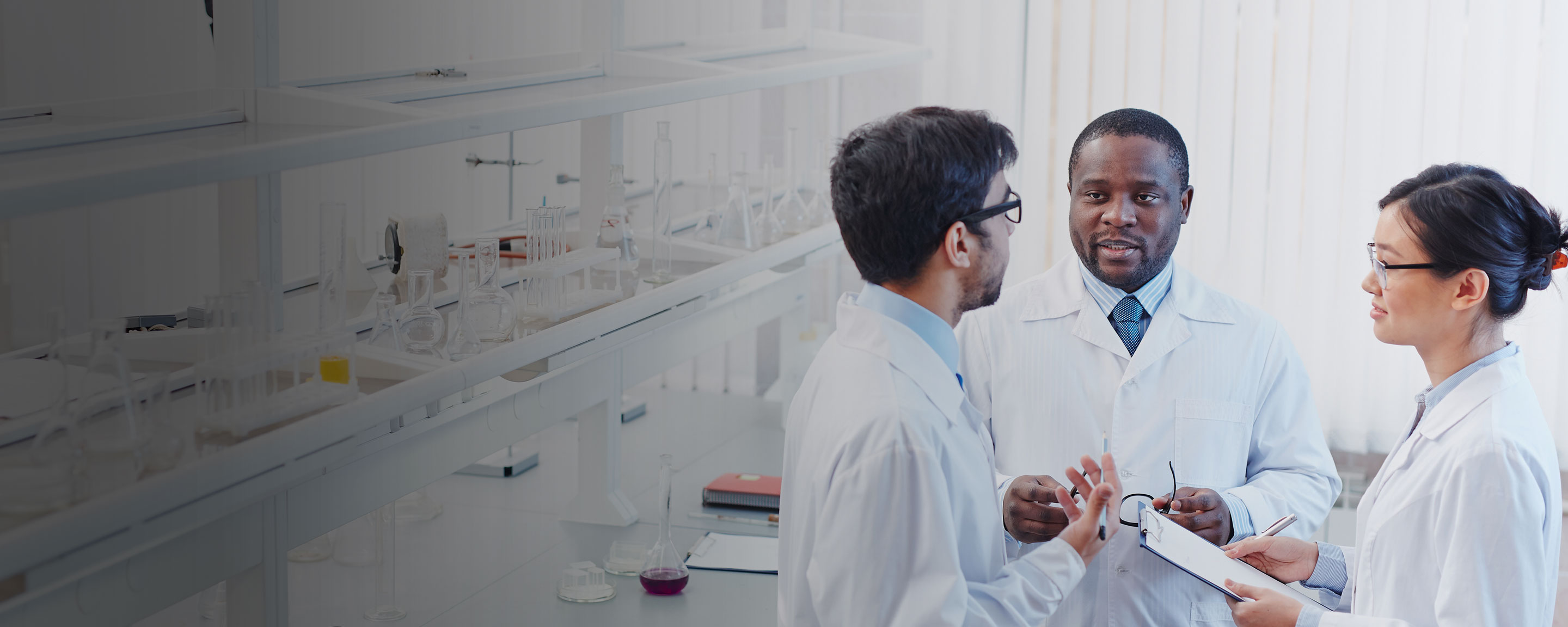 Consistent chemicals Three scientists gathered in an office